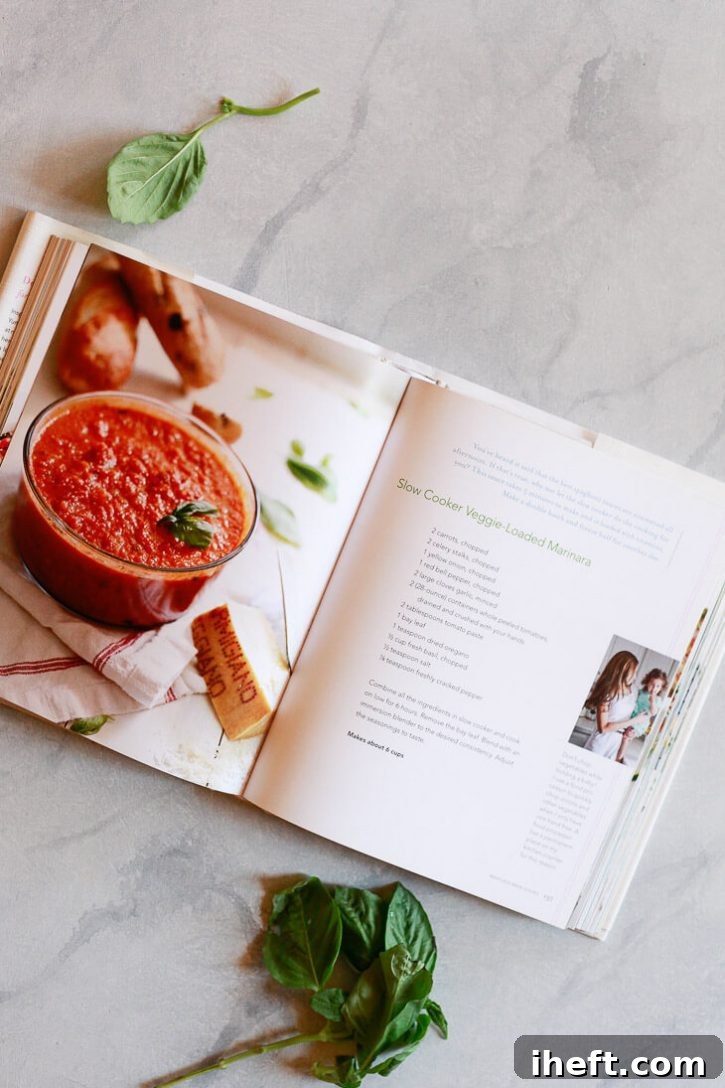 The Yummy Mummy Kitchen cookbook open to the Slow Cooker Marinara Sauce recipe, highlighting its popularity.