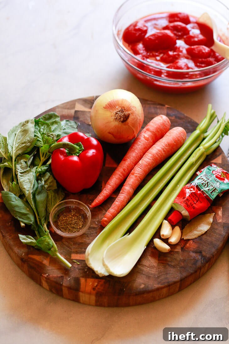 Fresh vegetables, including carrots, celery, onion, and bell pepper, neatly arranged on a cutting board, ready to be transformed into a delicious crockpot spaghetti sauce.