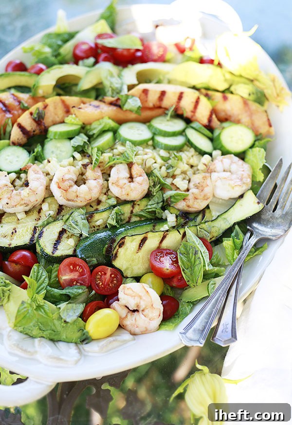 Colorful grilled vegetables including zucchini and corn, arranged beautifully on a salad