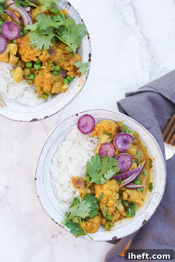 Rice and Gobi Matar Indian coconut curry with cauliflower and peas garnished with fresh cilantro and purple radish. This easy curry recipe is made in the Instant Pot pressure cooker and is vegetarian or vegan and gluten free, perfect for a family dinner. 