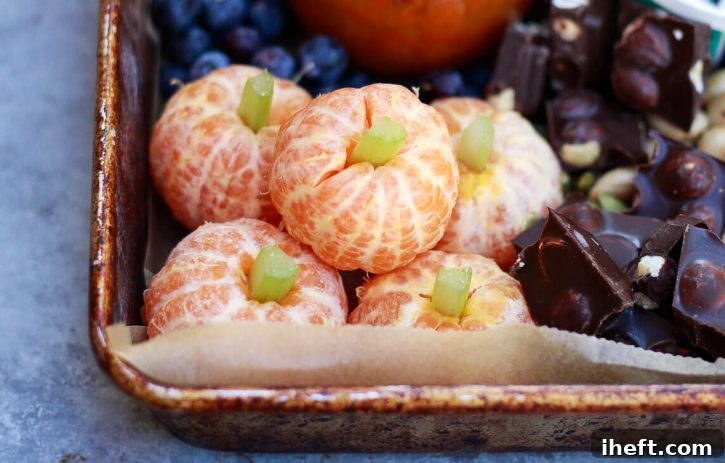 Charming tangerine pumpkins artfully crafted from peeled Cuties mandarins, adorned with a small piece of celery inserted into the center to create a realistic stem.