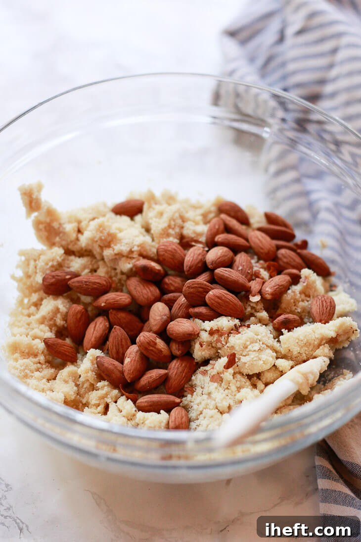 Whole, toasted almonds are added to the rich almond flour biscotti dough, ready to be incorporated into this gluten-free recipe.