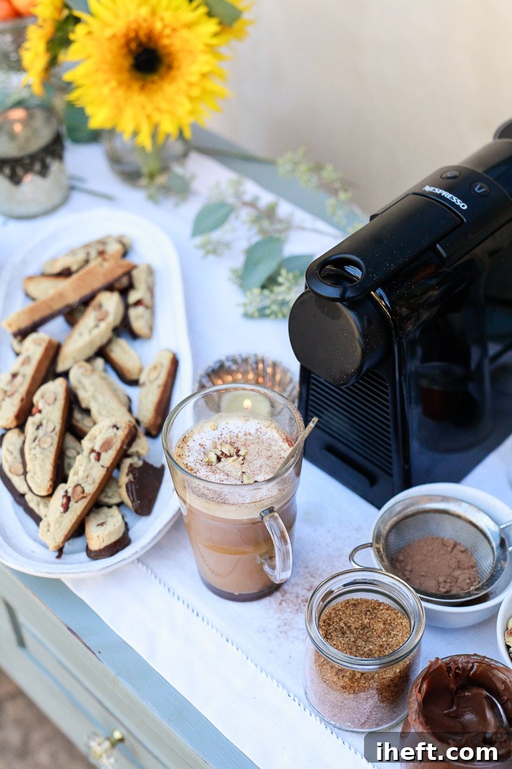 Nespresso machine on a beautifully decorated table with homemade biscotti and fresh flowers, creating an inviting coffee bar.