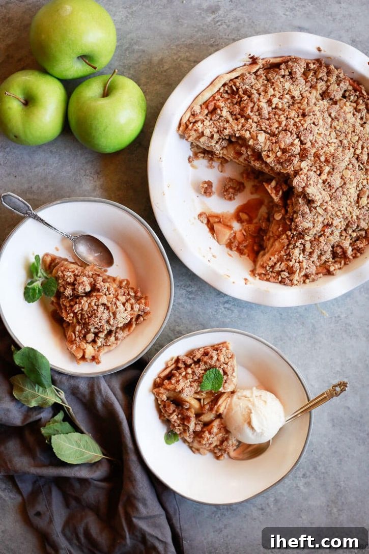 Apple crumble pie is served with vegan ice cream. This beautiful vegan apple pie has a crumb topping made with oats, coconut sugar, and almond flour. It's gluten-free and delicious for Thanksgiving or Christmas. 