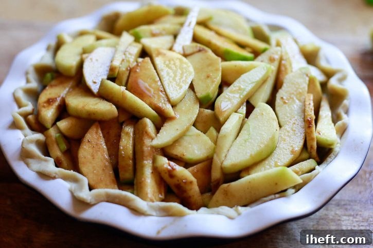 Apple pie filling piled into a pie shell