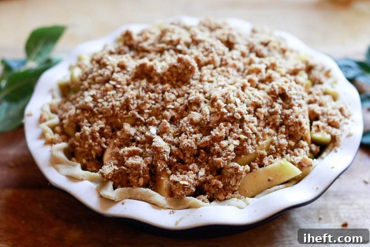 Oatmeal crumble on top of an apple crumble pie before baking. 