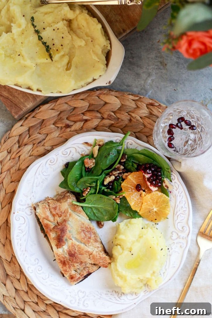 A beautiful vegan holiday (Thanksgiving or Christmas) dinner menu with vegan olive oil truffle mashed potatoes, vegetarian Wellington, and spinach salad with oranges and pomegranate. 