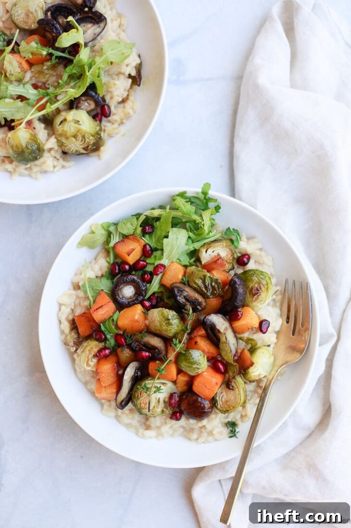 Instant Pot vegetable risotto in bowls on a marble countertop. Creamy simple risotto is toped with roasted mushrooms, butternut squash, and Brussels sprouts for a beautiful vegan dinner. 