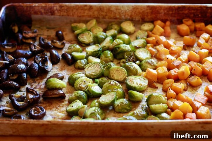 A sheet pan of roasted vegetables: mushrooms, Brussels sprouts, and butternut squash are ready to top Instant pot vegetable risotto. 