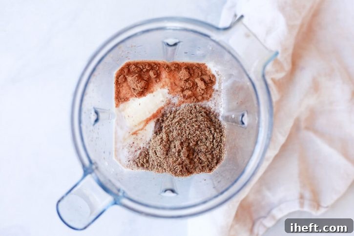 Blender filled with plant-based milk, flax meal, and banana for the custard.