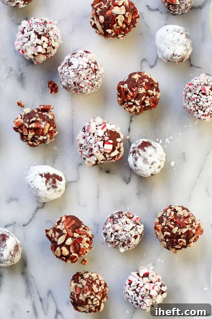 Homemade dark chocolate truffles coated in crushed candy canes, powdered sugar, and chopped nuts. These easy vegan chocolate truffles are made with chocolate and coconut cream. 