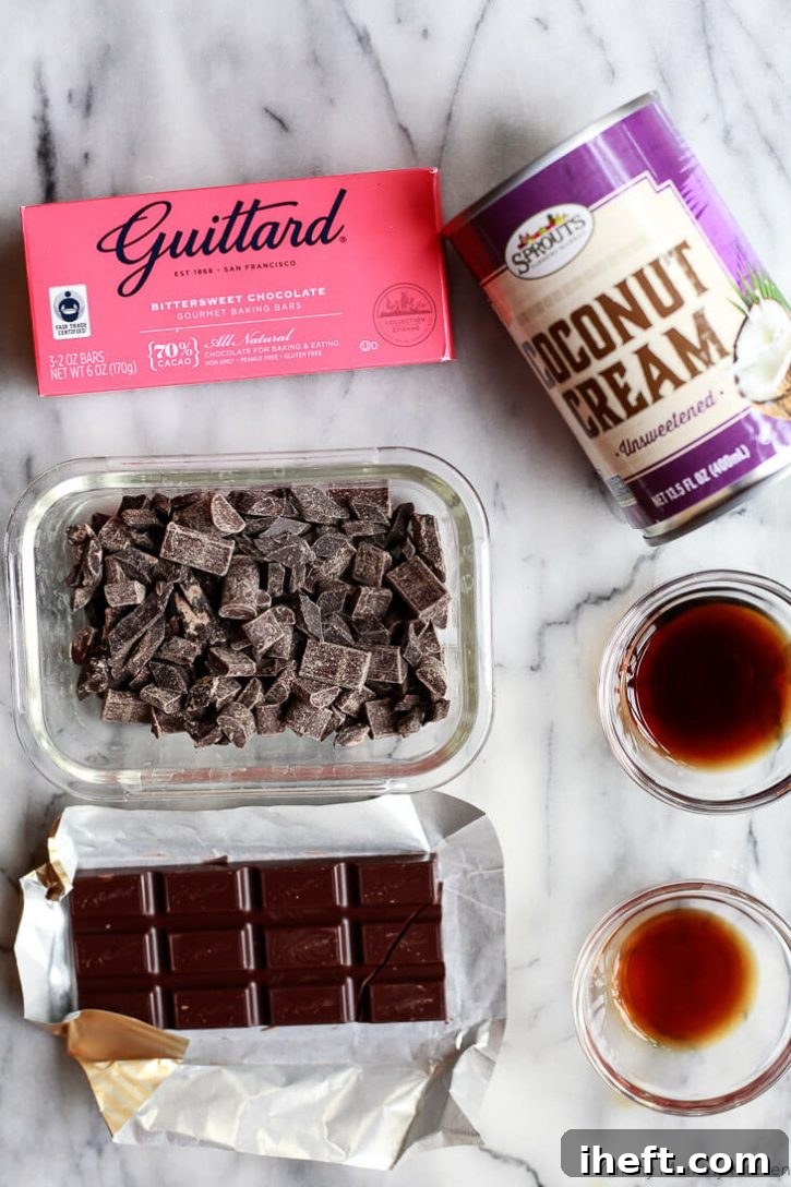 Ingredients for homemade chocolate truffles on a marble countertop. Guittard bittersweet chocolate, vegan semisweet chocolate, vanilla extract, coffee, and coconut cream. 