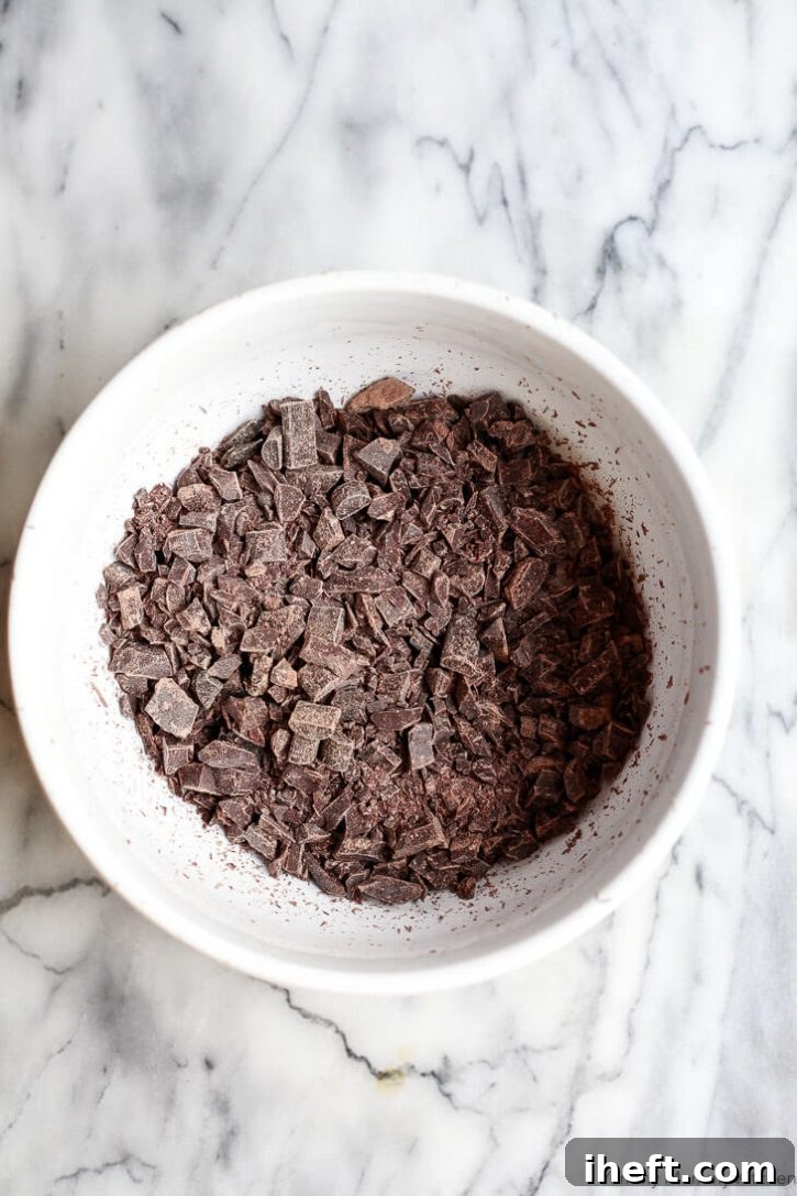Finely chopped semisweet and bittersweet chocolates in a bowl to make vegan chocolate truffles. 