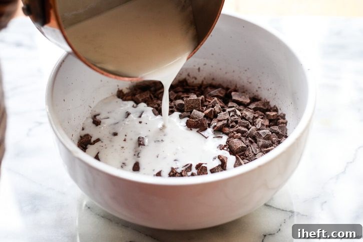 Hot coconut cream is poured over finely chopped chocolate to make homemade dark chocolate truffles. 