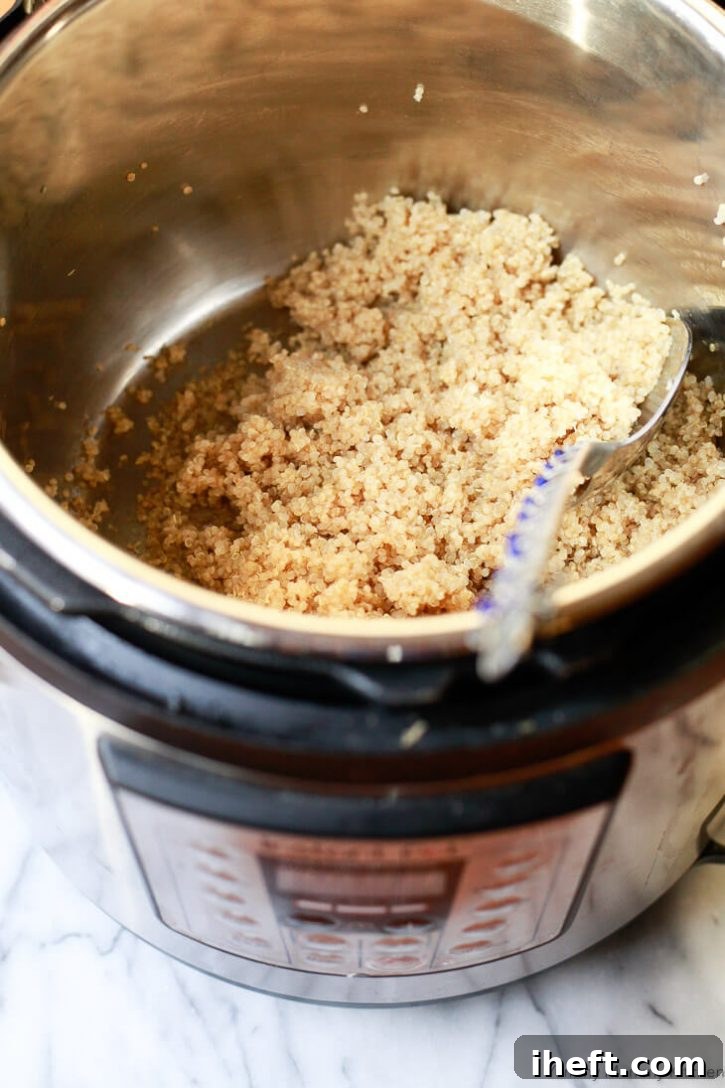 An Instant Pot pressure cooker filled with fluffy, cooked quinoa, ready for assembly.