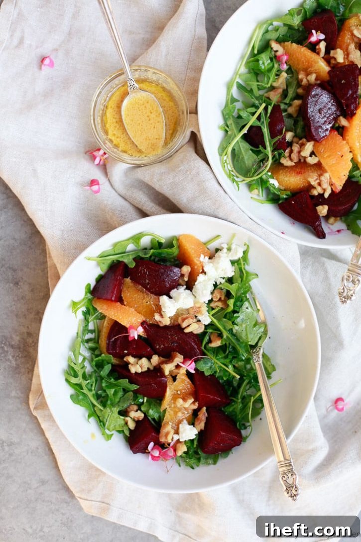 Bowls of beautiful beet salad over arugula with orange segments. The perfect winter salad. 