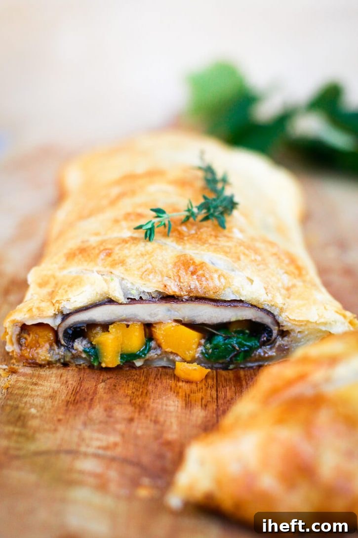 Vegetarian Mushroom Wellington with portobello mushrooms, butternut squash, and spinach in puff pastry is a beautiful vegetarian and vegan Christmas dinner main course. 