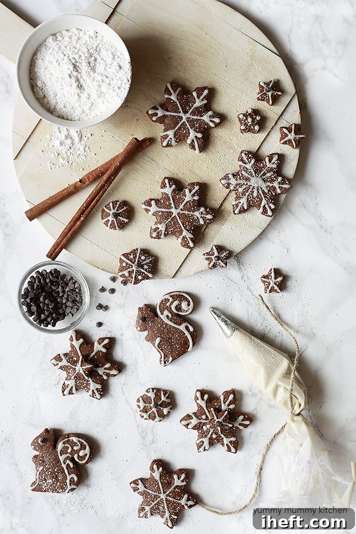 Cute decorated vegan gingerbread cookies sit on a marble countertop. 