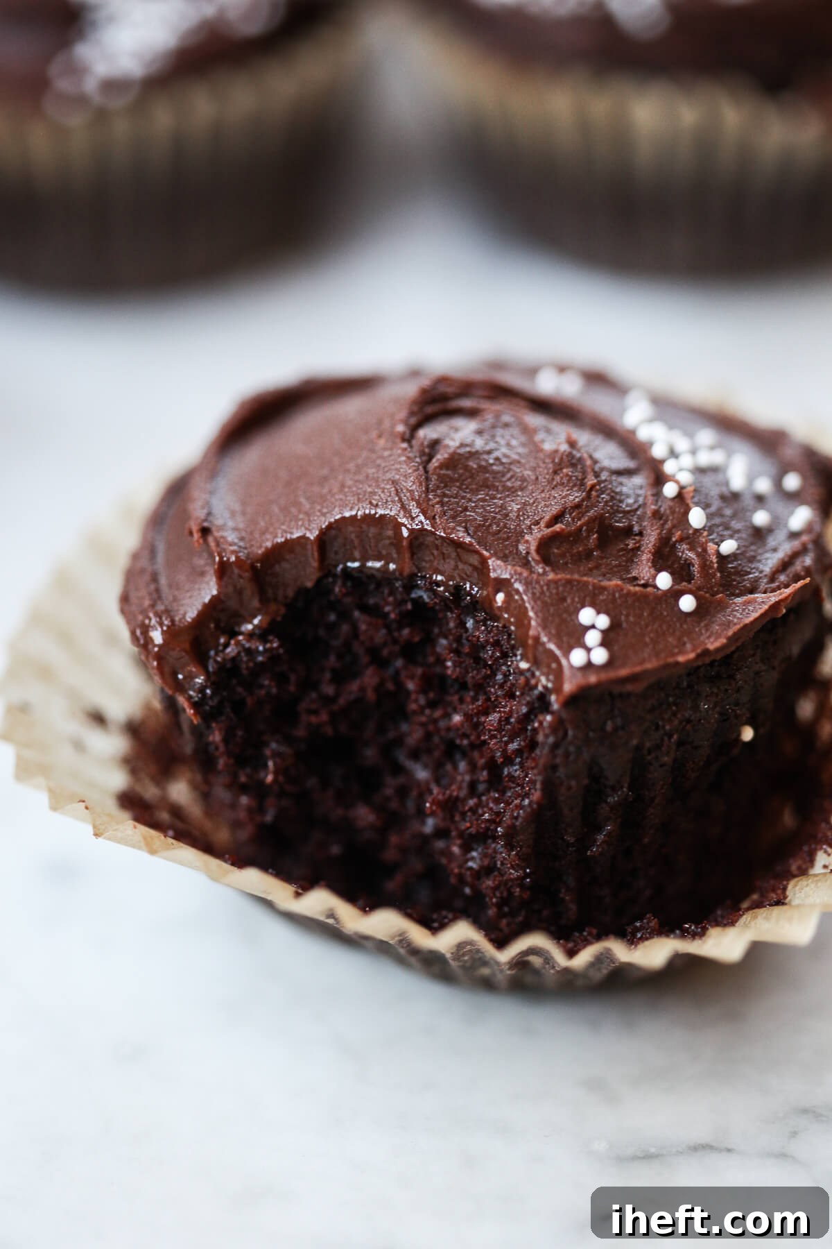 Delicious and moist vegan chocolate cupcakes topped with rich frosting.