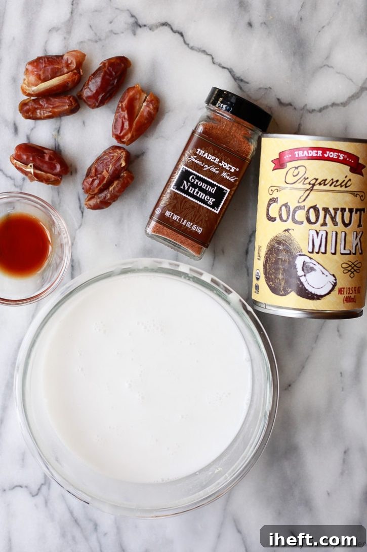 Vegan eggnog ingredients on a counter including dates, nutmeg, coconut milk, almond milk, and vanilla. 