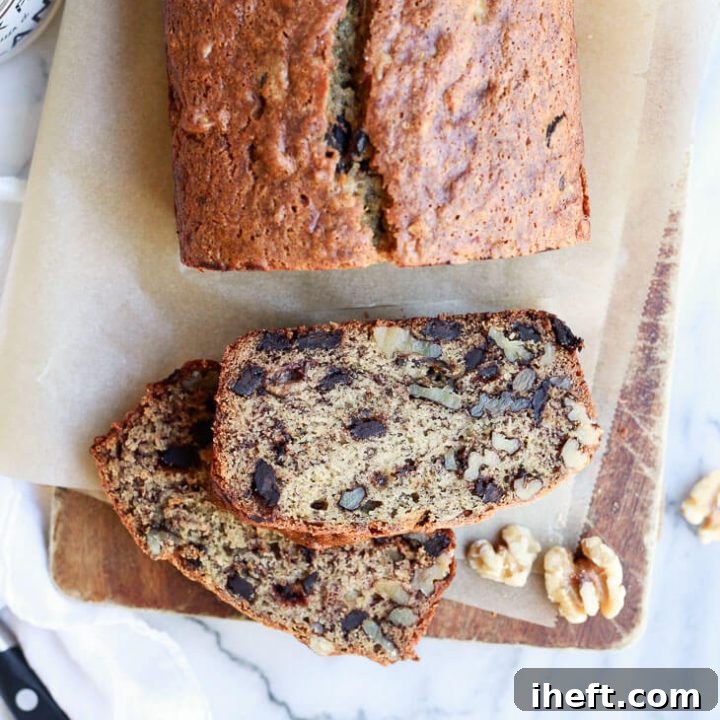 Vegan banana bread loaf and sliced with walnuts and chocolate chunks