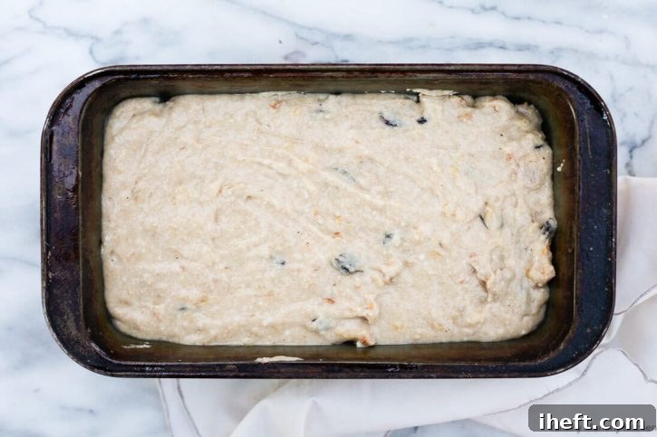Vegan banana bread batter poured into a loaf pan, ready for baking.
