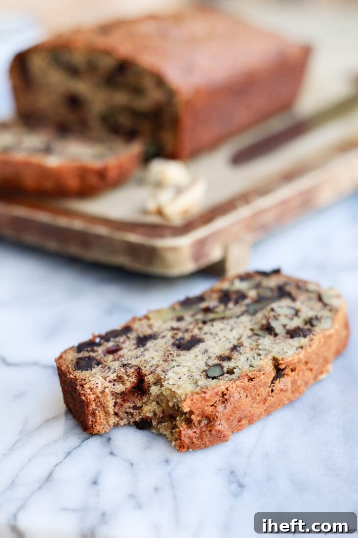 Freshly baked vegan banana bread loaf, golden brown and perfectly risen, cooling on a wire rack.