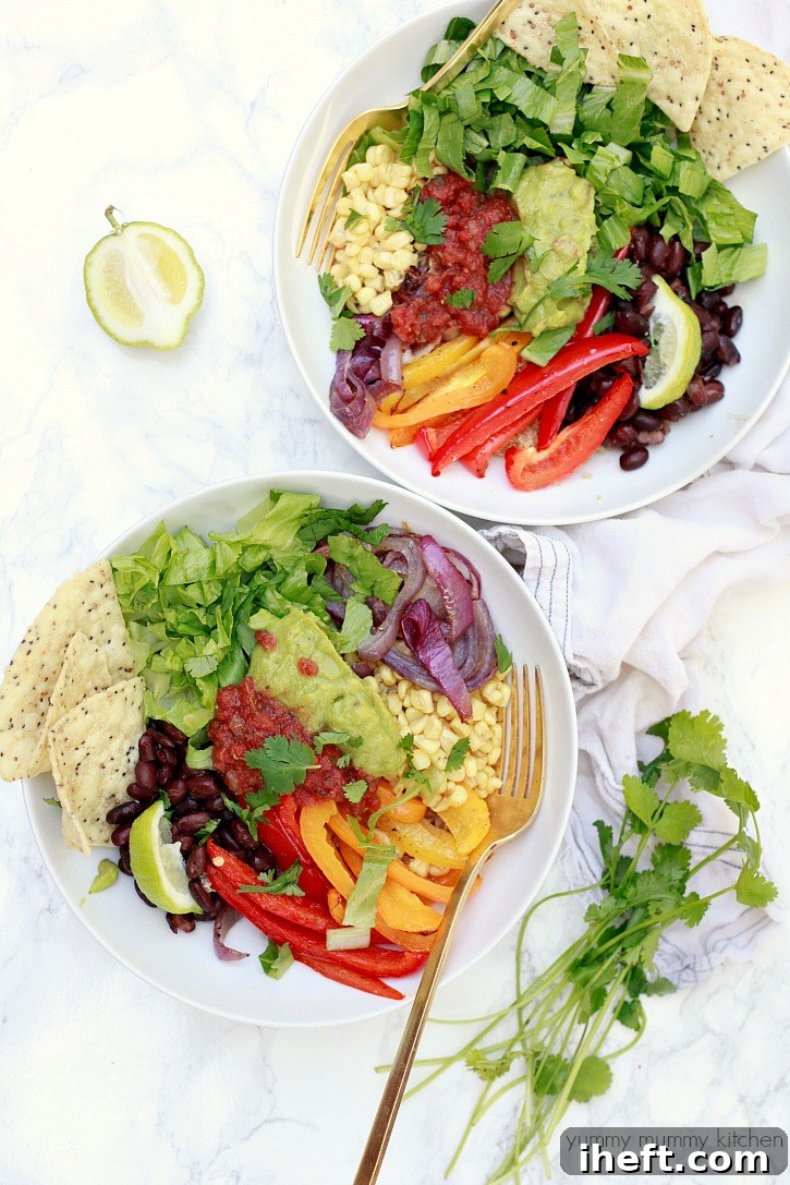 Burrito bowls with peppers, beans, lettuce, and guacamole for an easy vegan meal prep lunch. 