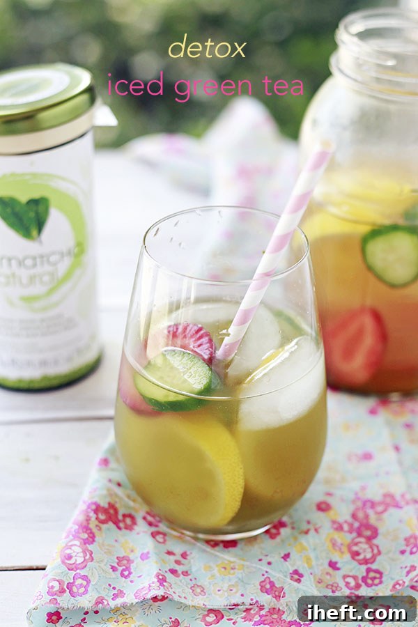 Ingredients for a detox iced green tea with cucumber, lemon, and strawberries.