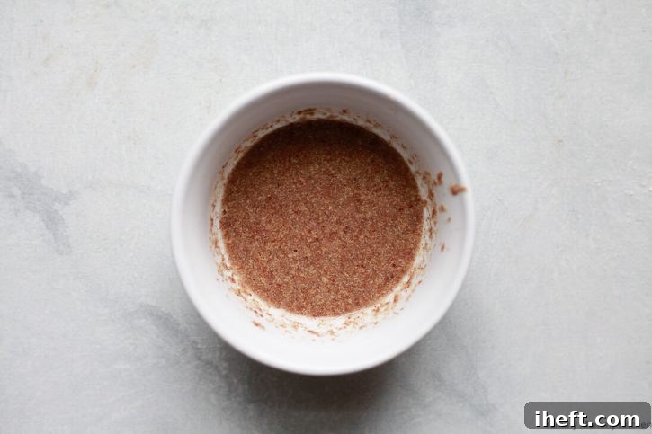 A small bowl with a flax egg inside for making vegan oatmeal cookies. 