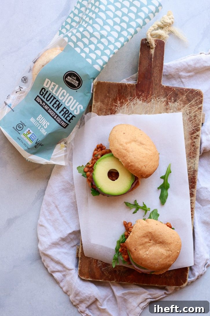 Two vegan lentil sloppy joes with avocado and arugula on a cutting board for a delicious vegetarian vegan plant-based lunch. 