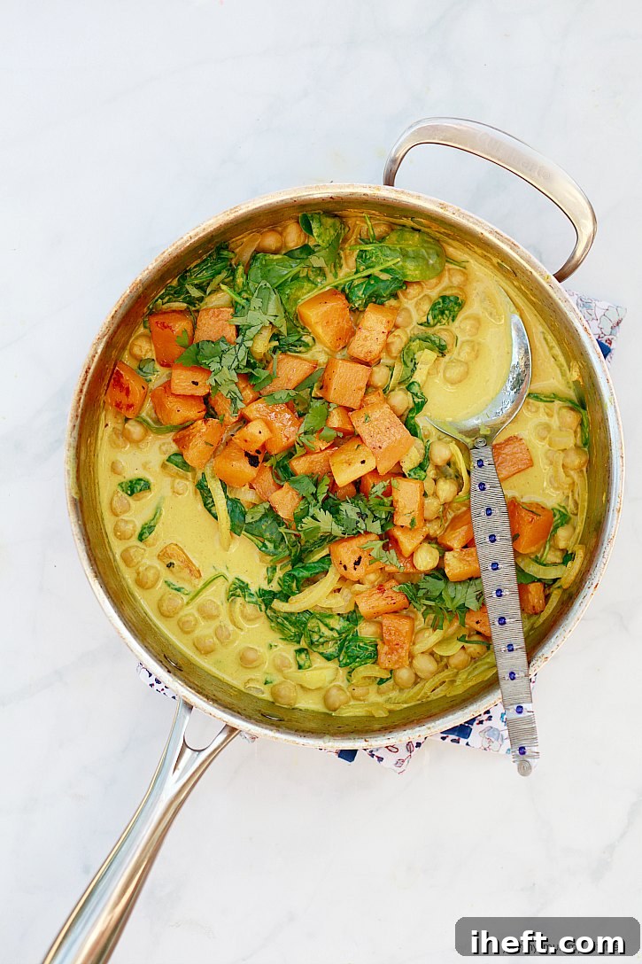 This easy coconut chickpea curry is beautifully topped with golden roasted butternut squash.