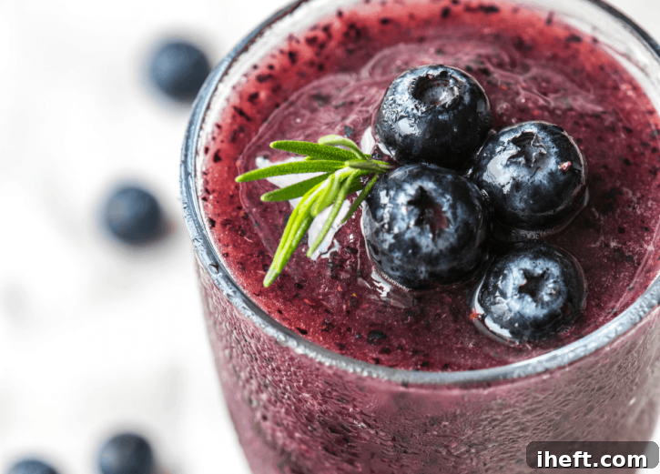 Beautiful purple blueberry green smoothie in a glass. 