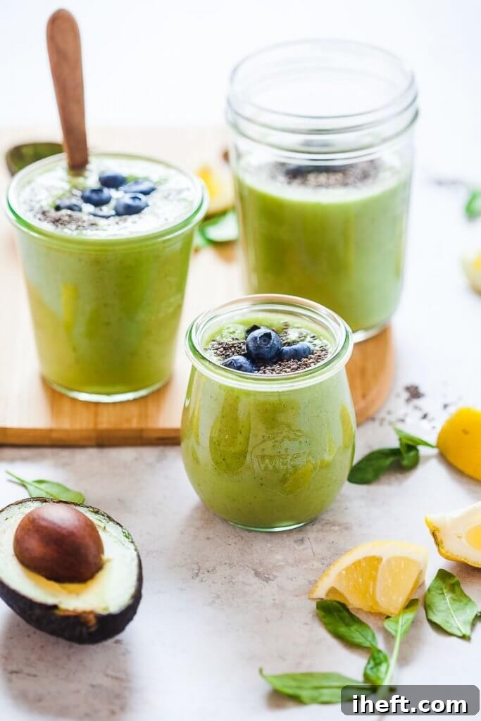 Beautiful green smoothies garnished with blueberries and chia seeds.