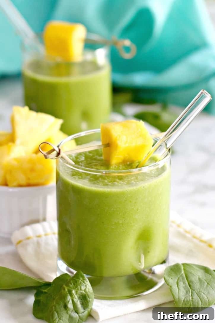 Green smoothies with glass straws and pineapple.