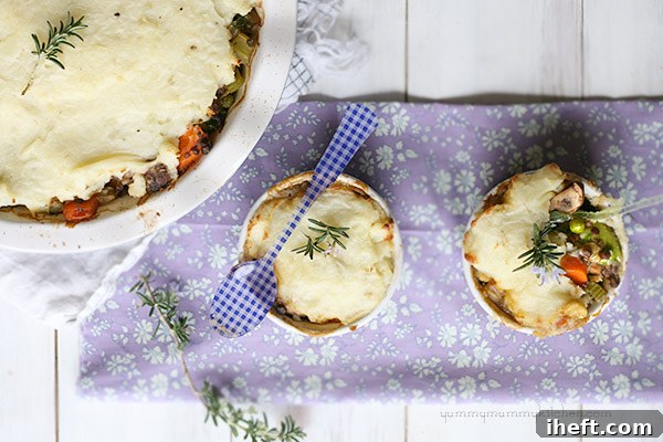 Hearty Vegan Shepherd's Pie with a golden mashed potato topping, served in individual ramekins, ready for a comforting meal.