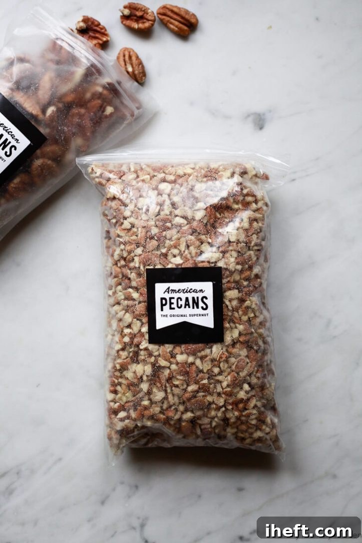 A bag of chopped American Pecans on a white marble countertop. 