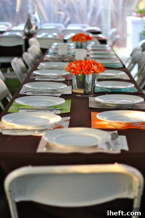 A festive Friendsgiving table adorned with creative scrapbook paper placemats, ready for a large gathering.