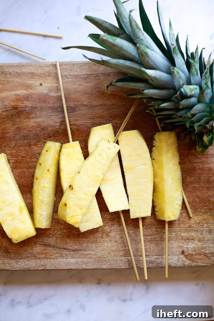Freshly cut pineapple spears on skewers. A healthy and fun snack idea for kids.