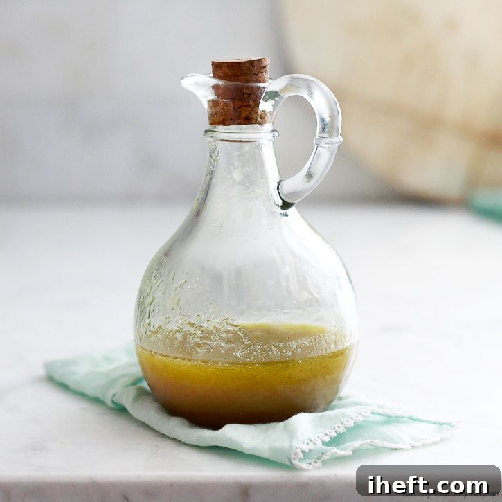 A simple yet elegant Apple Cider Vinaigrette in a glass cruet.