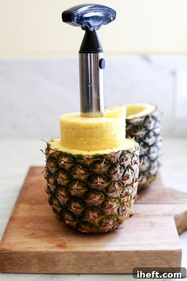 A pineapple is expertly cored and sliced into perfect rings, showcasing the preparation process for fresh fruit.