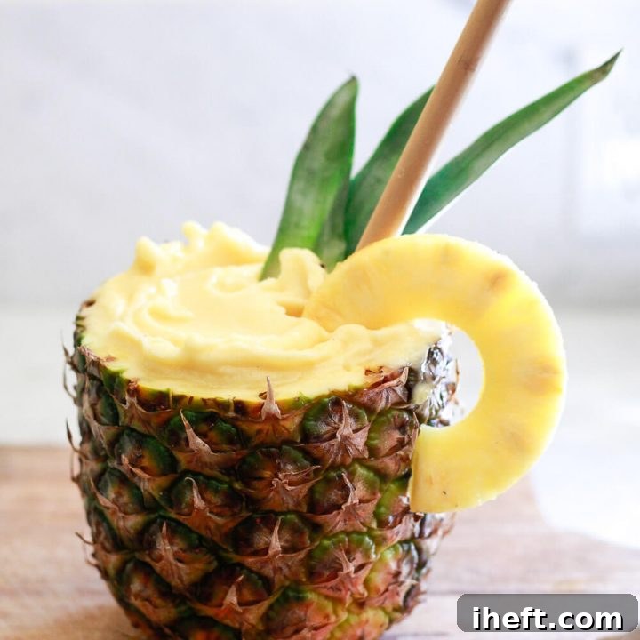 A beautifully presented Pineapple Smoothie, ready to be enjoyed, garnished with fresh fruit.