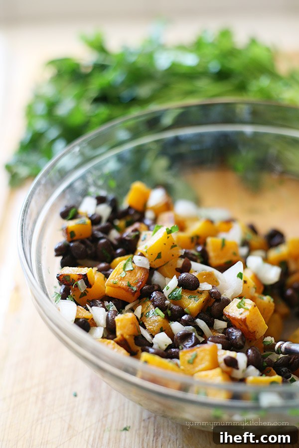 Close-up of the flavorful butternut squash and black bean filling, showcasing chopped cilantro and onions.