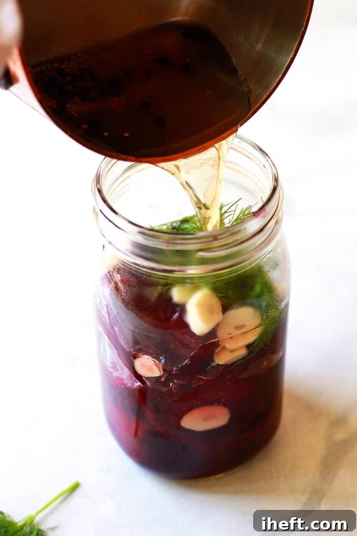 A sealed glass jar of homemade quick pickled beets, featuring vibrant red beets and green dill, ready for refrigeration.