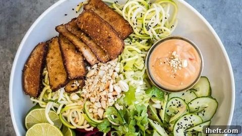 Healthy spiralized vegetable noodles with smoked tofu and peanut sauce