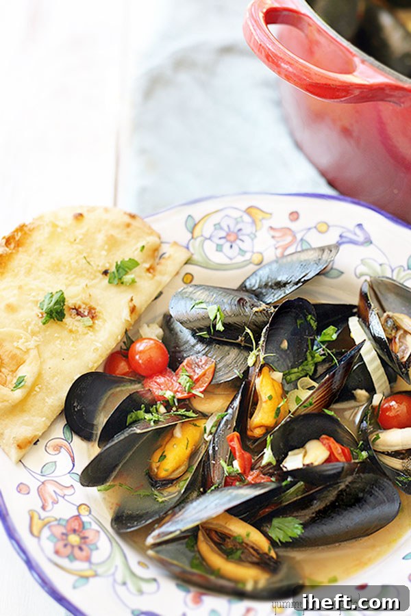 Mussels steaming in a pot with vegetables and broth, their shells beginning to open.