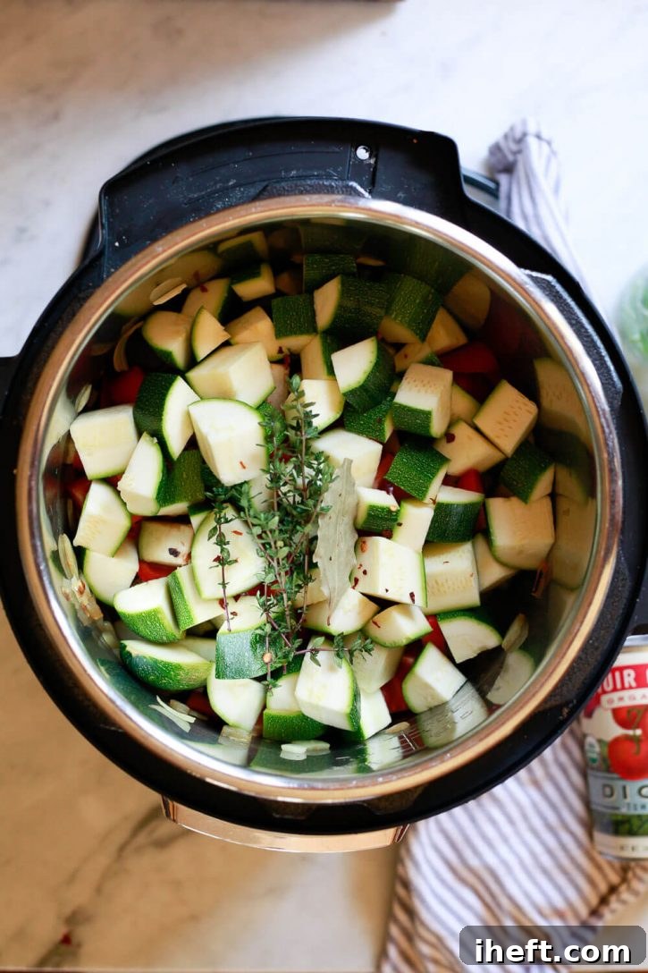 The ingredients for rustic ratatouille beautifully layered in an Instant Pot pressure cooker, ready for cooking.