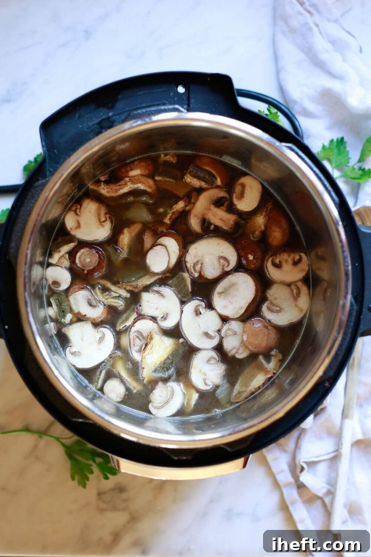 All the prepped ingredients for mushroom risotto are neatly arranged inside an Instant Pot, ready for cooking.