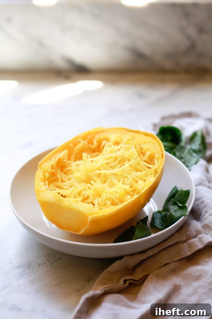 Half of a cooked spaghetti squash in a bowl. 