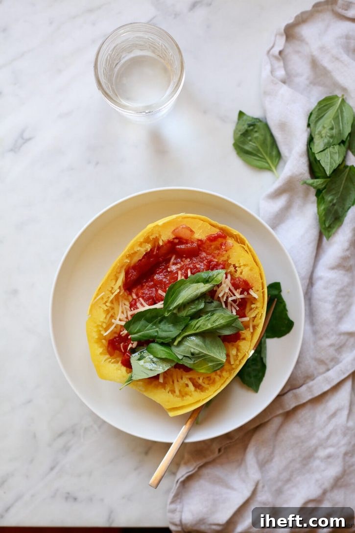 Instant Pot spaghetti squash half topped with tomato basil spaghetti sauce. 